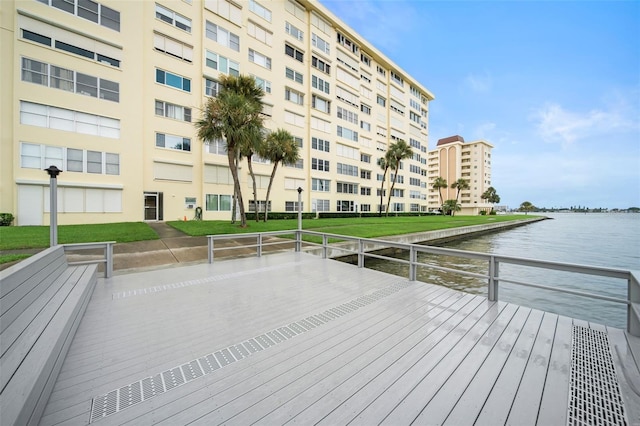 dock area featuring a lawn and a water view