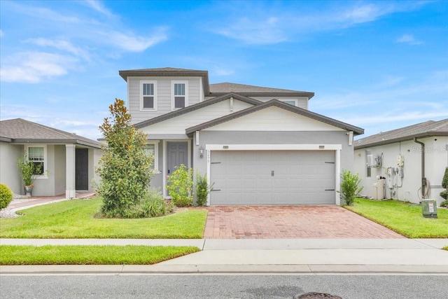 view of front of home with a garage and a front lawn