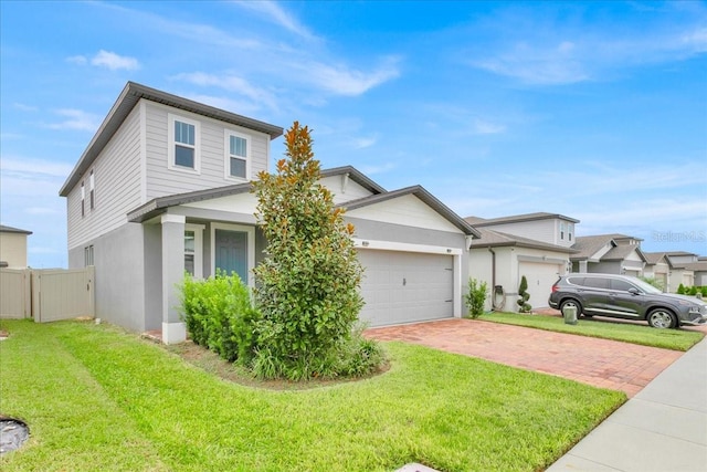 view of front of property featuring a front lawn and a garage