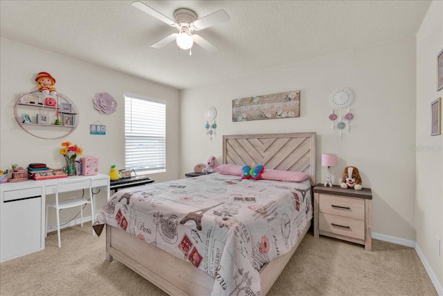 carpeted bedroom featuring a textured ceiling and ceiling fan