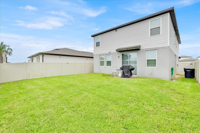 rear view of property with a yard