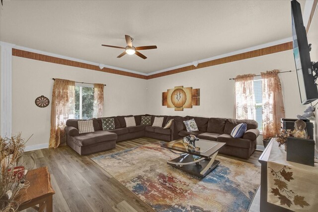 living room featuring ornamental molding, hardwood / wood-style flooring, and ceiling fan