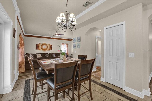 dining space featuring ceiling fan with notable chandelier and crown molding