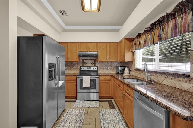 kitchen with crown molding, appliances with stainless steel finishes, sink, and decorative backsplash