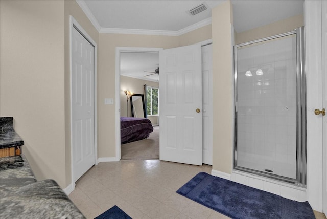 bathroom featuring crown molding, ceiling fan, and a shower with door