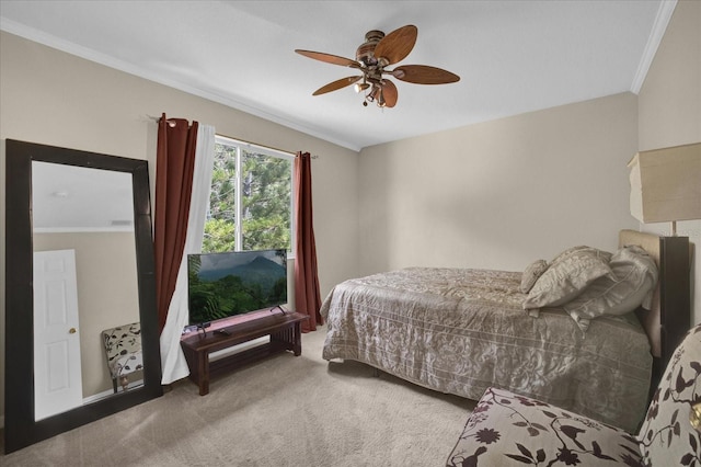 carpeted bedroom featuring crown molding and ceiling fan