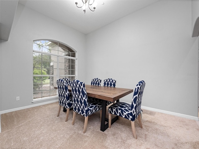 dining room featuring carpet flooring and baseboards