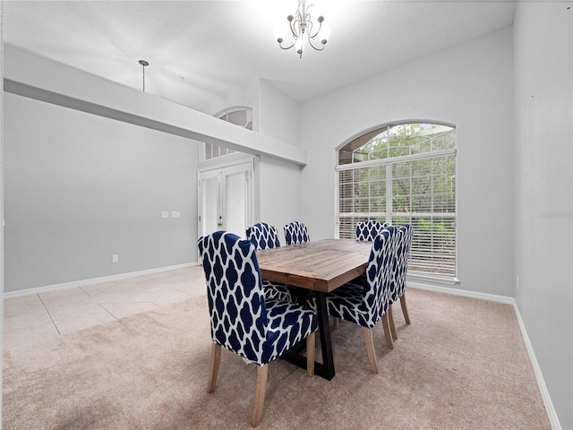 dining room with light tile patterned floors, light colored carpet, baseboards, and an inviting chandelier