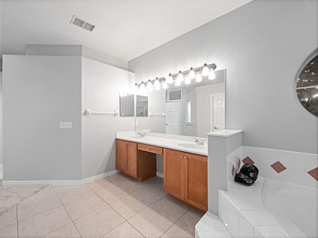 bathroom featuring a garden tub, double vanity, visible vents, a sink, and tile patterned flooring