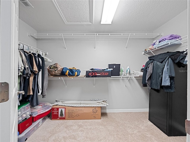 walk in closet featuring carpet floors and visible vents