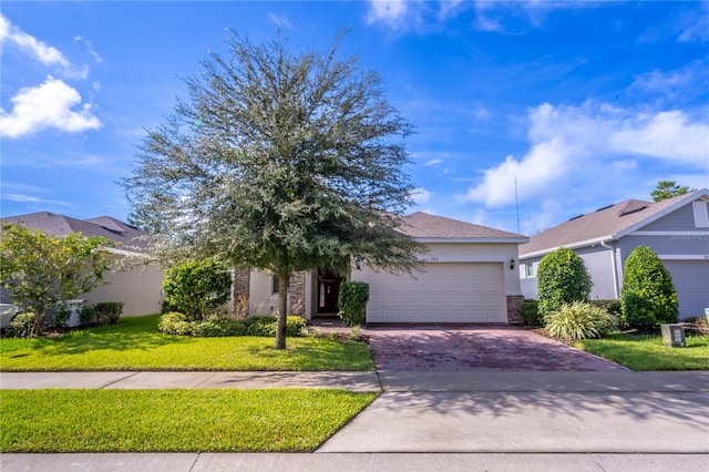 view of front of home with a front yard and a garage