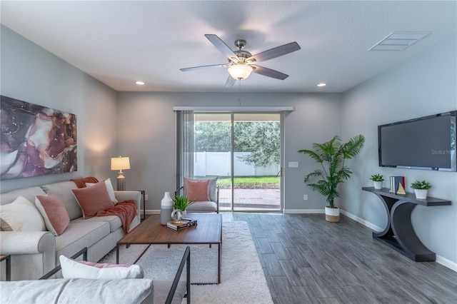 living room with ceiling fan and dark hardwood / wood-style flooring