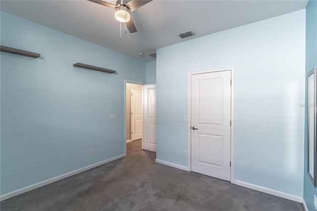 unfurnished bedroom with ceiling fan and dark colored carpet