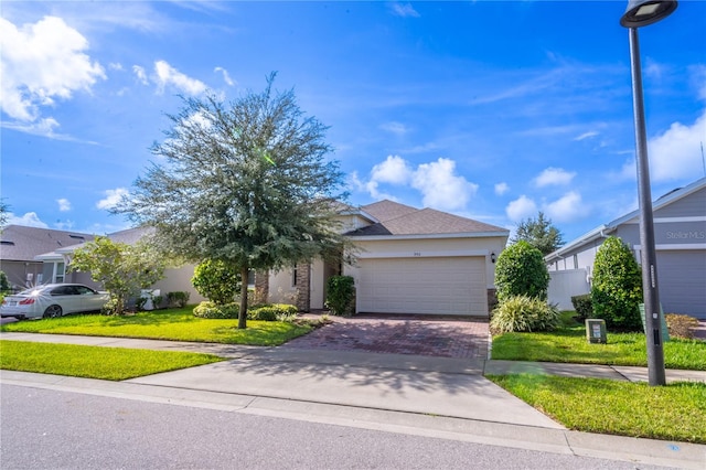 obstructed view of property featuring a garage and a front lawn