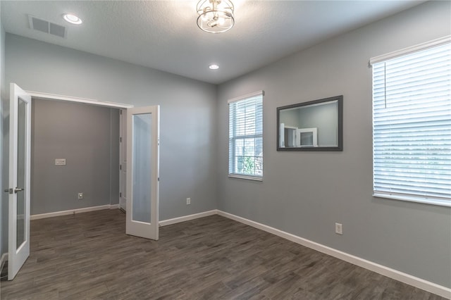 interior space with dark hardwood / wood-style floors and a textured ceiling