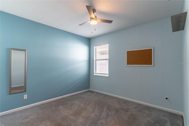 carpeted spare room with a textured ceiling and ceiling fan