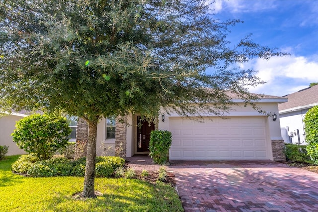 obstructed view of property with a garage and a front lawn