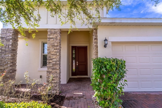 doorway to property with a garage