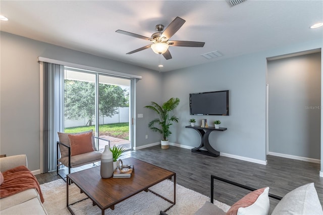 living room featuring a ceiling fan, recessed lighting, baseboards, and wood finished floors