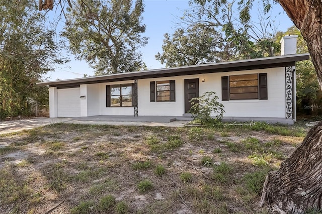 single story home featuring covered porch and a garage