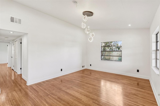 unfurnished dining area with light wood-type flooring, visible vents, plenty of natural light, and baseboards