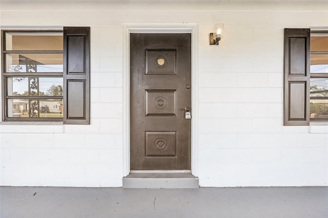 view of exterior entry with concrete block siding