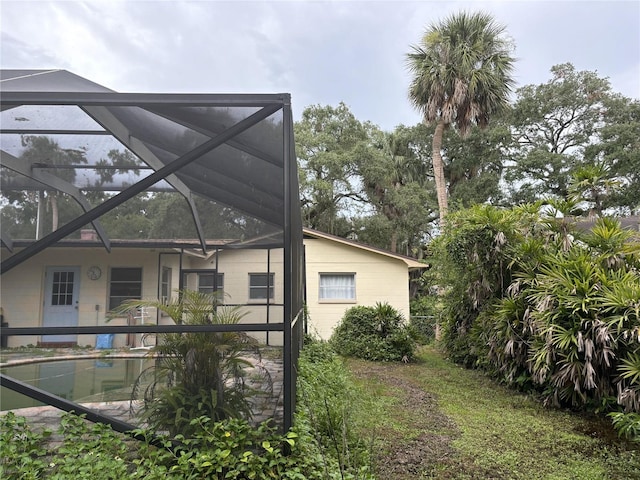 back of house with glass enclosure