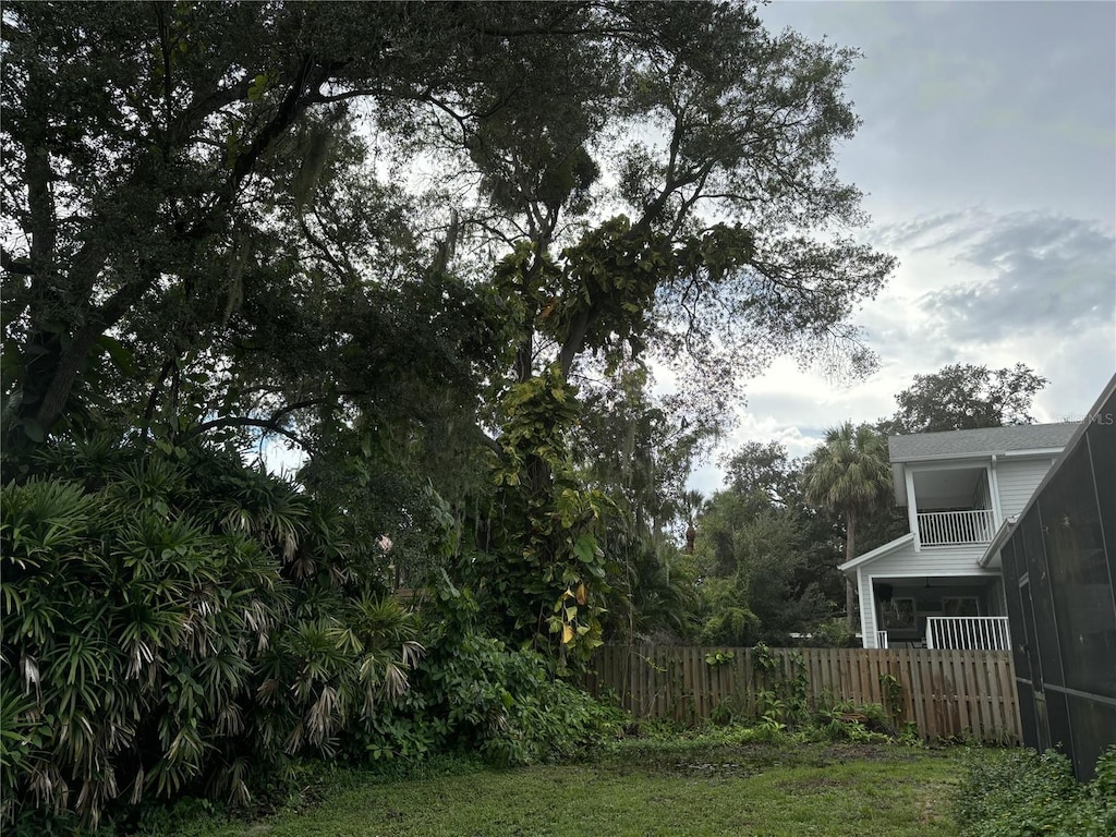 view of yard with a balcony and a sunroom