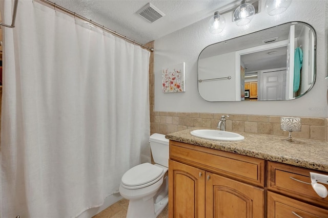 bathroom with tile patterned flooring, vanity, a textured ceiling, curtained shower, and toilet