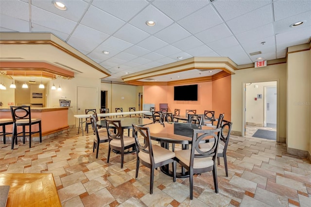 dining room featuring a drop ceiling and crown molding