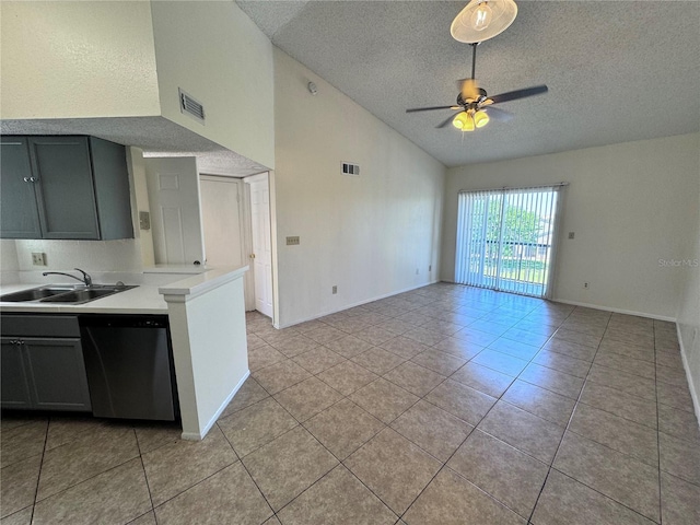 kitchen featuring dishwasher, ceiling fan, sink, high vaulted ceiling, and a textured ceiling