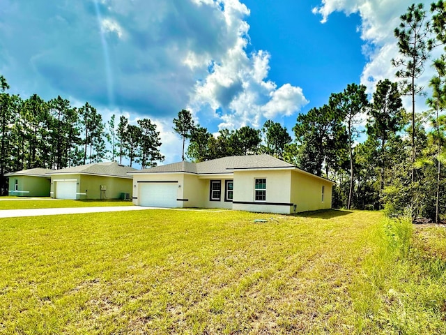 ranch-style house featuring a garage and a front lawn