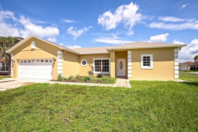 ranch-style house featuring a front lawn, driveway, an attached garage, and stucco siding