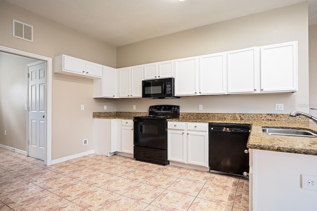 kitchen with visible vents, stone counters, black appliances, white cabinetry, and a sink