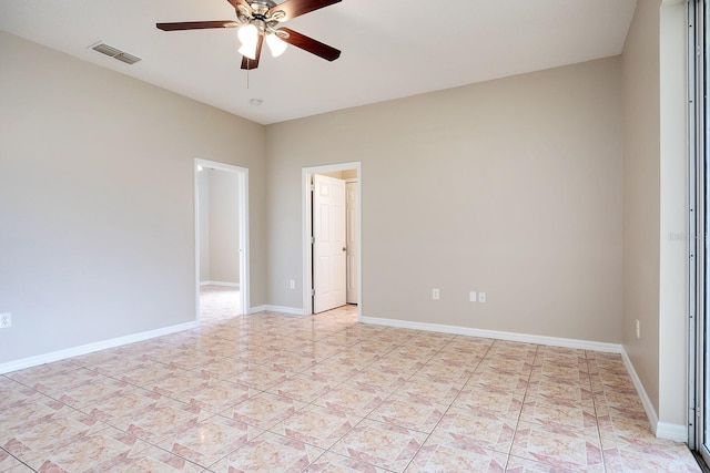 unfurnished room featuring a ceiling fan, light tile patterned flooring, visible vents, and baseboards