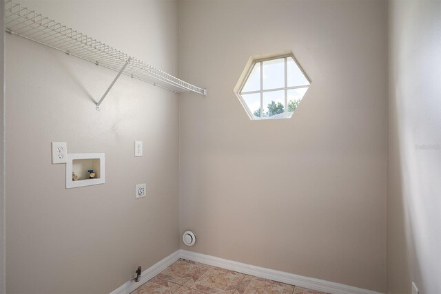 laundry area with hookup for a washing machine, hookup for an electric dryer, gas dryer hookup, laundry area, and baseboards