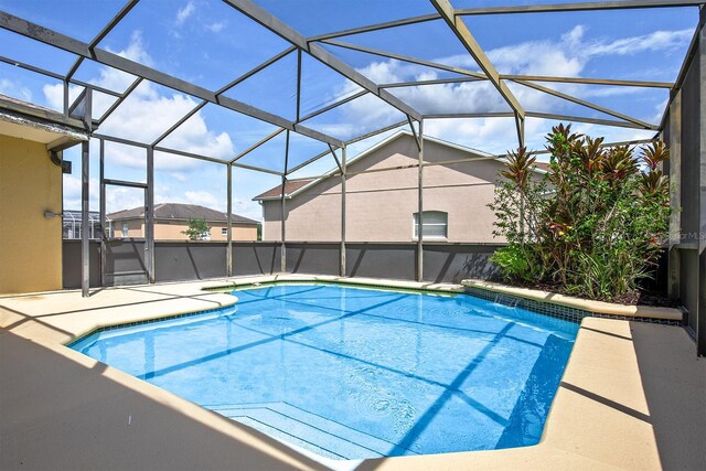 pool with a lanai and a patio