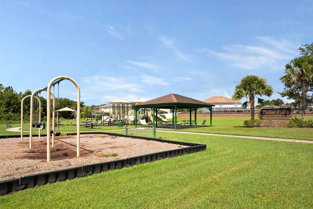 community jungle gym with a lawn and a gazebo