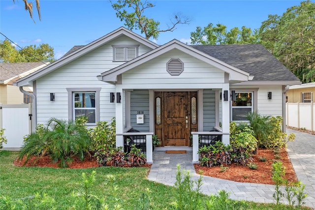 bungalow-style house featuring a front lawn and a porch