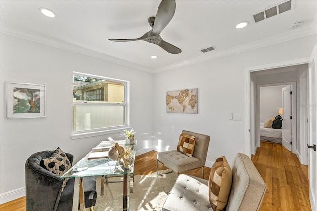 home office featuring ceiling fan, ornamental molding, and light hardwood / wood-style floors