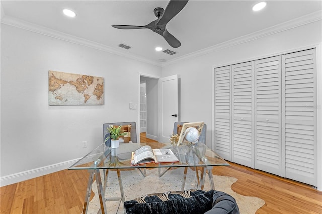 office with ceiling fan, ornamental molding, and light hardwood / wood-style floors