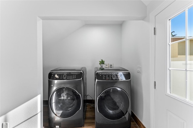 clothes washing area featuring separate washer and dryer and hardwood / wood-style flooring