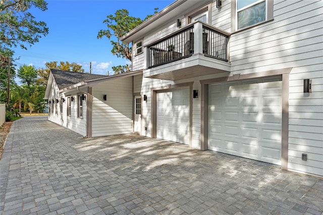 exterior space with a balcony and a garage