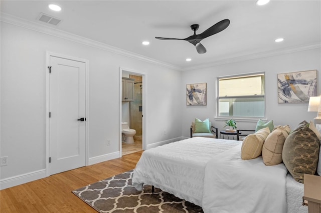 bedroom featuring light wood-type flooring, ornamental molding, ensuite bath, and ceiling fan