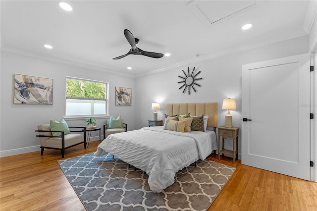 bedroom with hardwood / wood-style floors, ceiling fan, and ornamental molding