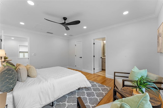 bedroom featuring ornamental molding, ensuite bathroom, ceiling fan, and light hardwood / wood-style floors