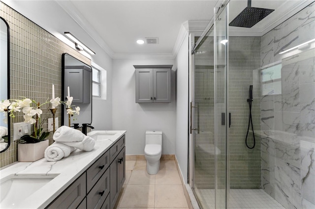 bathroom featuring vanity, a shower with shower door, toilet, ornamental molding, and tile patterned floors