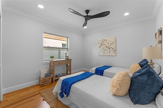 bedroom featuring ceiling fan, ornamental molding, and hardwood / wood-style floors