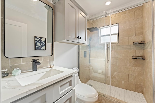 bathroom featuring vanity, toilet, an enclosed shower, and tasteful backsplash