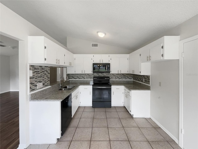 kitchen with vaulted ceiling, white cabinets, sink, and black appliances